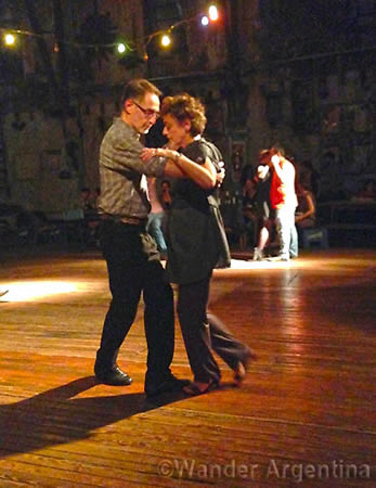 A couple dances tango on the dance floor at La Catedral de Tango in Buenos Aires