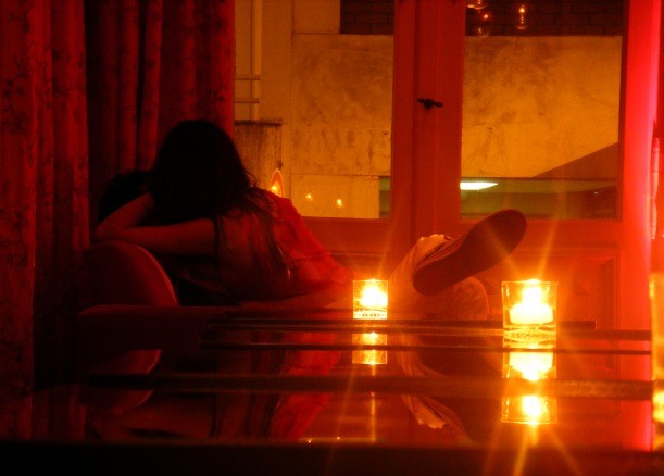 A coule making out in candlelit bar in the passionate city of Buenos Aires 
