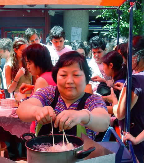 A woman preparing street food in Buenos Aires Chinatown 
