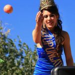 Vendimia Queen throwing an apple from her parade float
