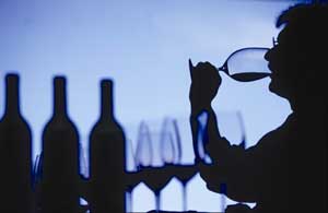 A silhouette of a man tasting wine at a Buenos Aires Wine Cellar 