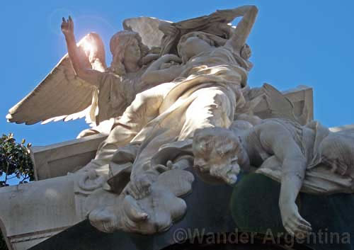 A sculptured tomb showing three angels in Recoleta cemetery in Buenos Aires 