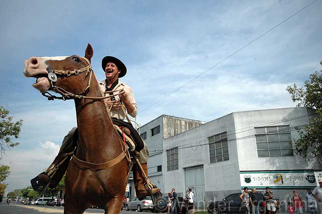 A smiling Argentine cowboy on a horse