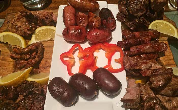 An asado (Argentine barbecue) appetizer of sausages and organ meatss