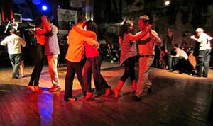People dancing in a milonga, or tango dancehall in Buenos Aires 