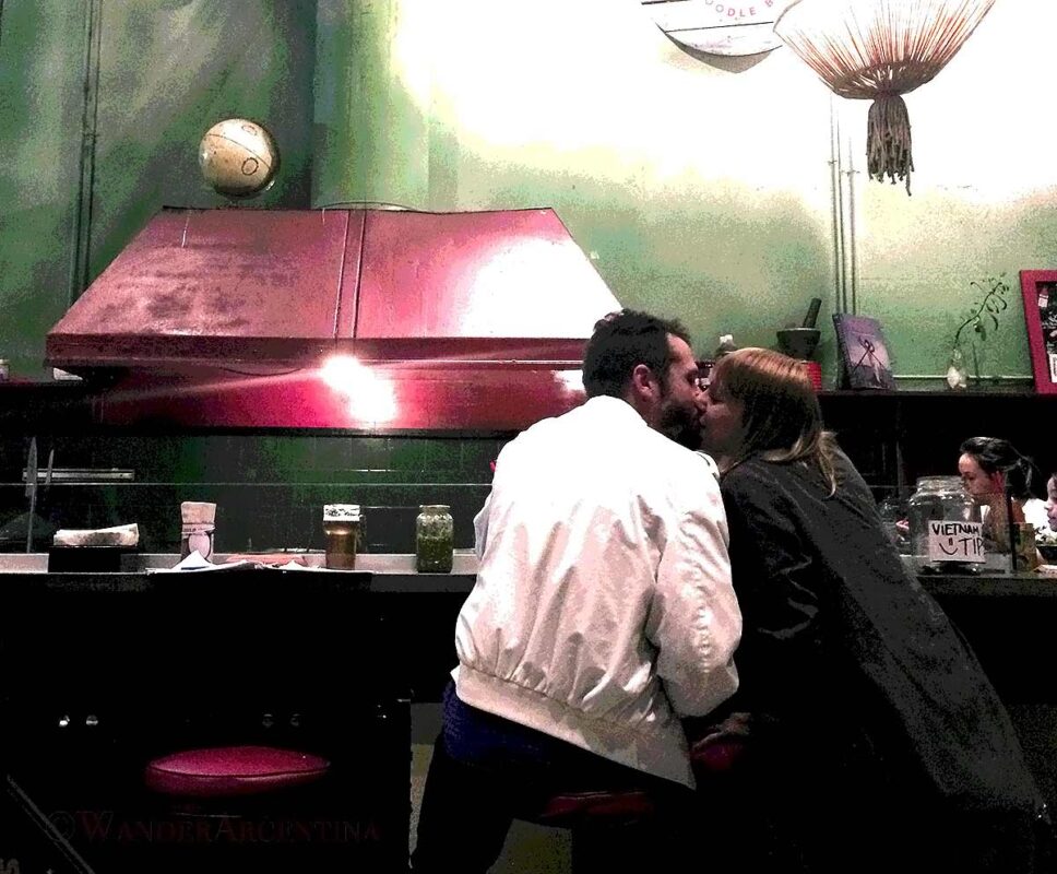 Couple kissing in a restaurant