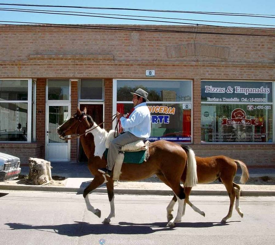 A gaucho on horseback on a city street