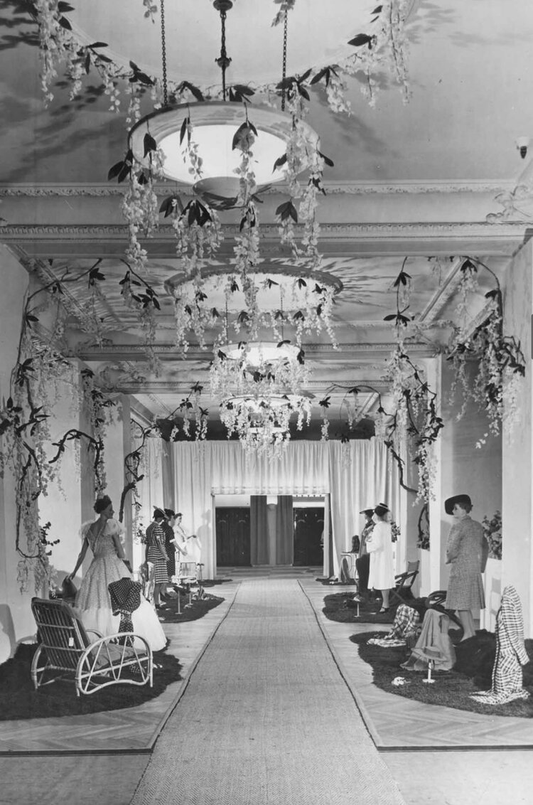 Harrods Buenos Aire in 1914 (black and white photo of decorated hallway with mannequins). 