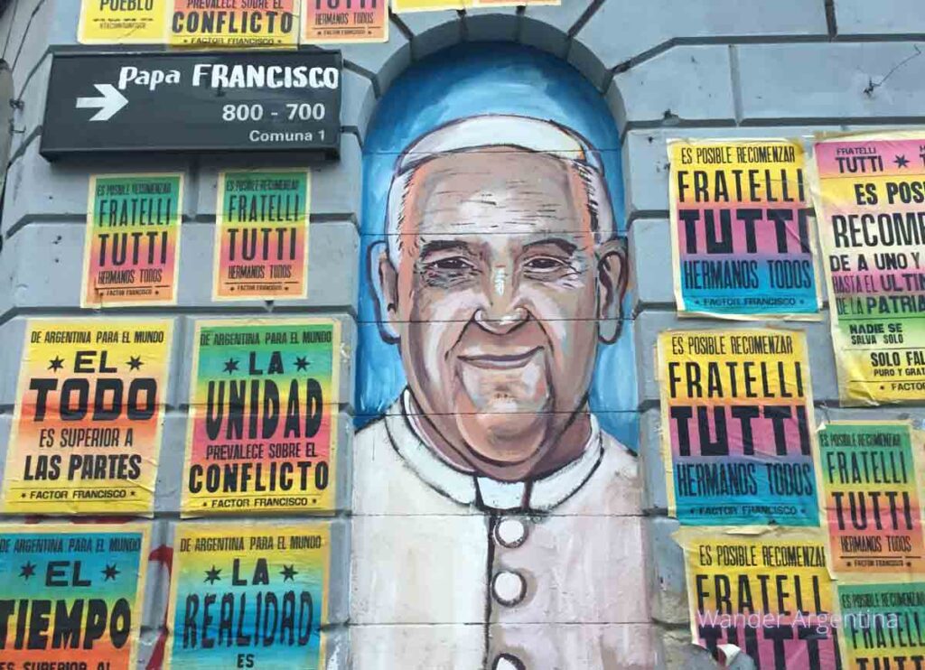 Street Art portrait of Pope Francis with street sign. 