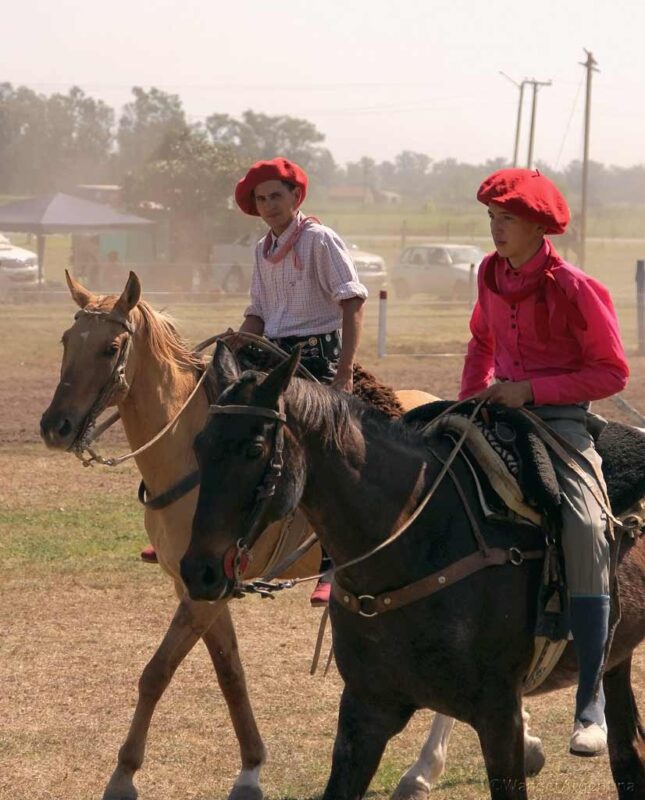 Two young gauchos on horseback